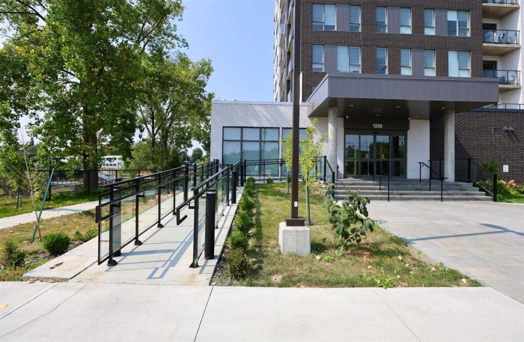 Entrée d’un immeuble en copropriété à Montréal avec rampe d’accès et hall vitré